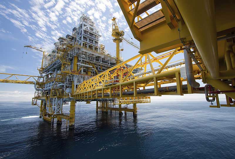 Large offshore oil rig complex rising from the ocean, showcasing Elevate Technology and Elevation Technology across various Industries Served.