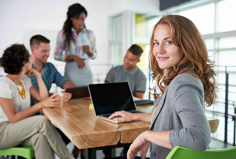 Diverse team of five collaborating in a modern office, highlighting Elevate Technology and Elevation Technology within various Industries Served.