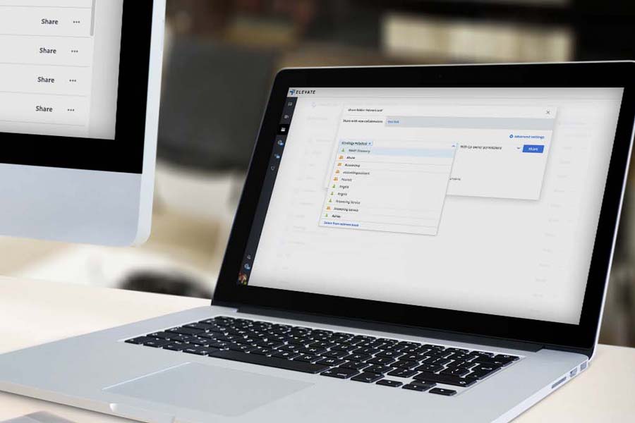 A clear product shot for Elevate Technology, showing a laptop on a desk with its screen displaying a user interface for file sharing and collaboration.