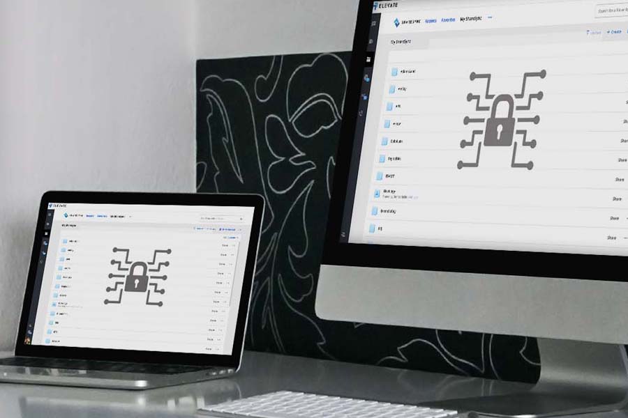A product shot for Elevate Technology's cybersecurity solutions. A laptop and a desktop monitor are shown side-by-side, both displaying a file management interface with a prominent digital lock icon. 