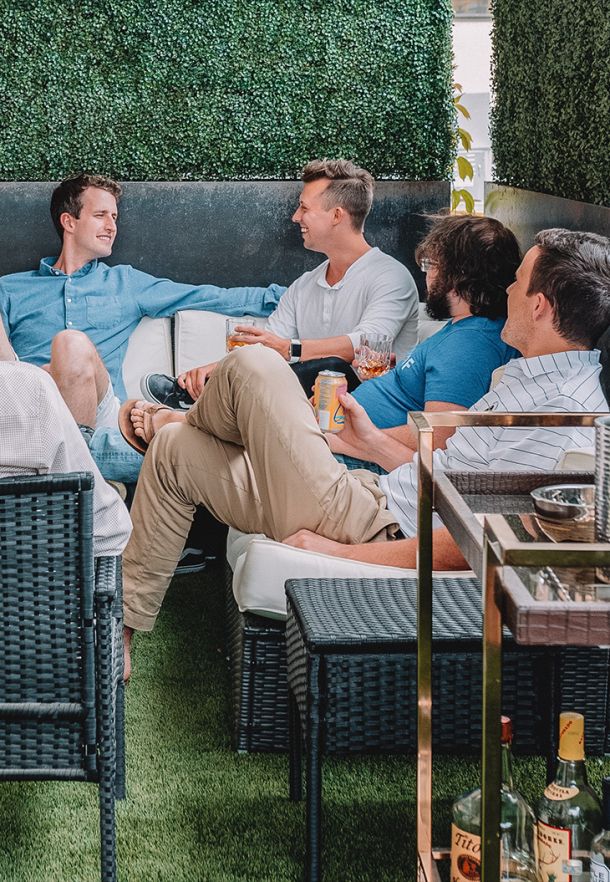  A group of professionals networking and socializing outdoors, highlighting team collaboration, business networking, and professional relationships.