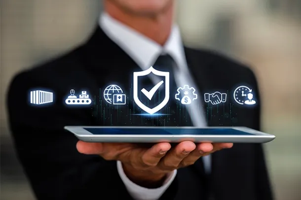Business professional holding a tablet with digital icons representing security and global connectivity, highlighting cloud hosting, business email, and cloud email by Elevation Technology.