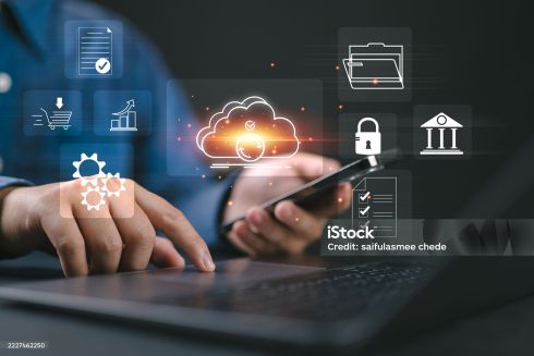 Professional using a laptop and mobile device for Elevate Technology and Elevation Technology workflows, featuring cloud-based phone system, Cloud PBX Phone System, Voicemail-to-email, and Hosted PBX data security.